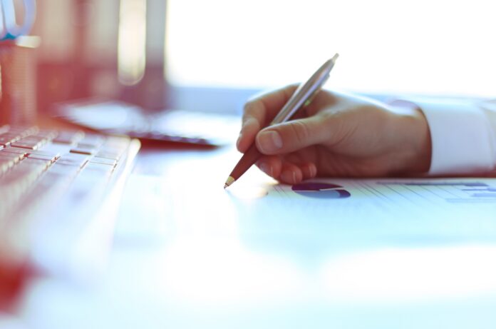 Close-up of graphs and charts analyzed by businesswoman